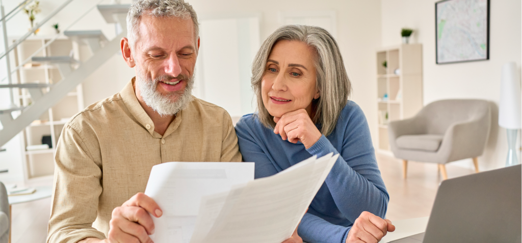 Man and woman looking at bank statement, pleased to see overdraft fees waived